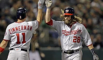 Washington Nationals&#39; Jayson Werth, right, is congratulated by Ryan Zimmerman after hitting a home run against the Oakland Athletics during the sixth inning of a baseball game Friday, June 2, 2017, in Oakland, Calif. (AP Photo/Ben Margot)