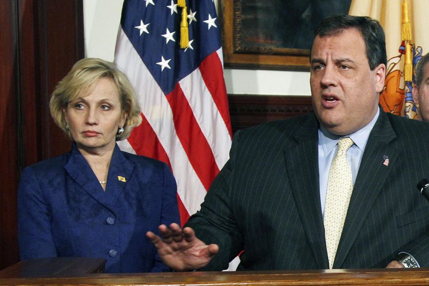 FILE – In this Dec. 22, 2011, file photo, New Jersey Lt. Gov. Kim Guadagno listens as Gov. Chris Christie announces staff changes in Trenton, N.J. Guadagno has been at Christie's side for the last eight years. Her Republican primary campaign to replace him has forced her to straddle a fine line between embracing the positive from her time in office and running away from the Christie legacy. (AP Photo/Mel Evans, File)