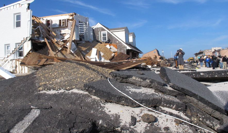 This Nov. 29, 2012 photo shows the remnants of a house and an oceanfront road in the Ortley Beach section of Toms River, N.J. destroyed by Superstorm Sandy a month earlier. A beach replenishment and dune construction project is underway in Ortley Beach nearly five years after the storm as New Jersey is closing in on its goal of having protective dunes along its coast. But pockets of resistance remain among residents fighting the dune plan in court. (AP Photo/Wayne Parry)