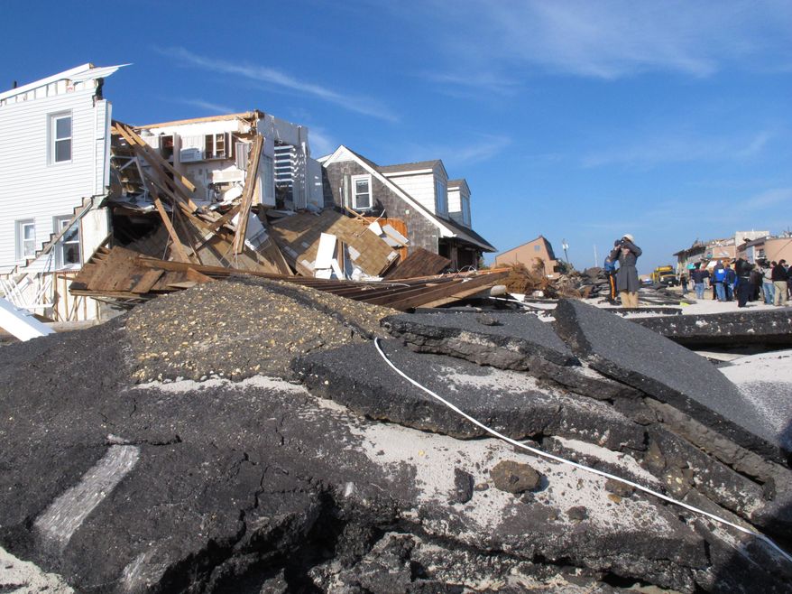 This Nov. 29, 2012 photo shows the remnants of a house and an oceanfront road in the Ortley Beach section of Toms River, N.J. destroyed by Superstorm Sandy a month earlier. A beach replenishment and dune construction project is underway in Ortley Beach nearly five years after the storm as New Jersey is closing in on its goal of having protective dunes along its coast. But pockets of resistance remain among residents fighting the dune plan in court. (AP Photo/Wayne Parry)