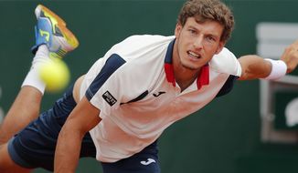 Spain&#39;s Pablo Carreno Busta serves against Canada&#39;s Milos Raonic during their fourth round match of the French Open tennis tournament at the Roland Garros stadium, in Paris, France. Sunday, June 4, 2017. (AP Photo/Christophe Ena)