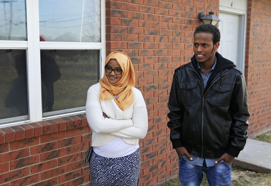 FILE - In this Feb. 3, 2017, file photo, Ifrah Ahmed, left, and Mursal Naleye stand outside a new walk-in clinic in Garden City, Kan. Kansas is launching a project to help immigrants in the meatpacking town get driver's licenses by offering them free translators when they take their exams. Naleye, who is from Somalia, is a volunteer in the pilot project, and Ahmed, who came to Kansas in 2012 from Kenya, plans to volunteer for the program. (AP Photo/Orlin Wagner, File)