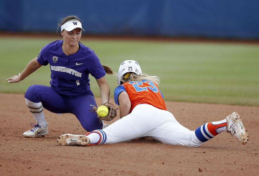 Florida's Nicole DeWitt (23) steals second as Washington's Ali Aguilar (1) applies the tag in the first inning during the Women's College World Series softball game in Oklahoma City, Sunday, June 4, 2017. (Sarah Phipps/The Oklahoman via AP) ia AP)