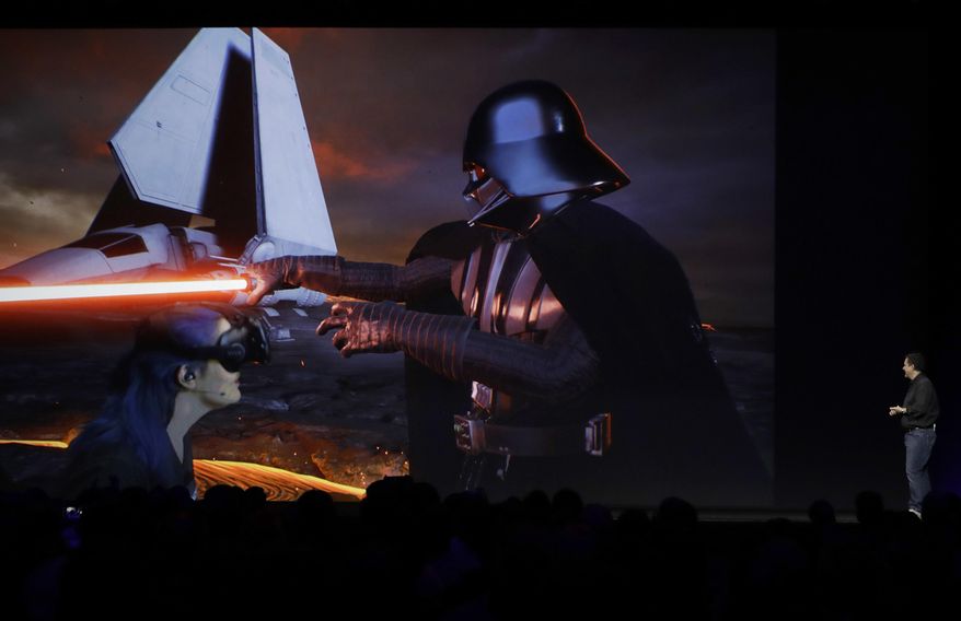 John Knoll of Industrial Light & Magic, right, speaks about virtual reality during an announcement of new products at the Apple Worldwide Developers Conference in San Jose, Calif., Monday, June 5, 2017. (AP Photo/Marcio Jose Sanchez)