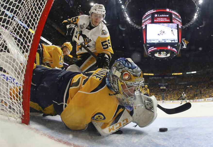 Nashville Predators goalie Pekka Rinne (35), of Finland, stops a shot by Pittsburgh Penguins center Jake Guentzel (59) during the second period in Game 4 of the NHL hockey Stanley Cup Final Monday, June 5, 2017 in Nashville, Tenn. (Bruce Bennett/Pool Photo via AP)