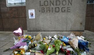 A floral tribute in the London Bridge area following Saturday&#x27;s attack in London, Monday, June 5, 2017. Police arrested several people and are widening their investigation after a series of attacks described as terrorism killed several people and injured more than 40 others in the heart of London on Saturday. (AP Photo/Alastair Grant)