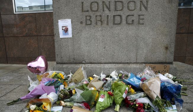 A floral tribute in the London Bridge area following Saturday's attack in London, Monday, June 5, 2017. Police arrested several people and are widening their investigation after a series of attacks described as terrorism killed several people and injured more than 40 others in the heart of London on Saturday. (AP Photo/Alastair Grant)