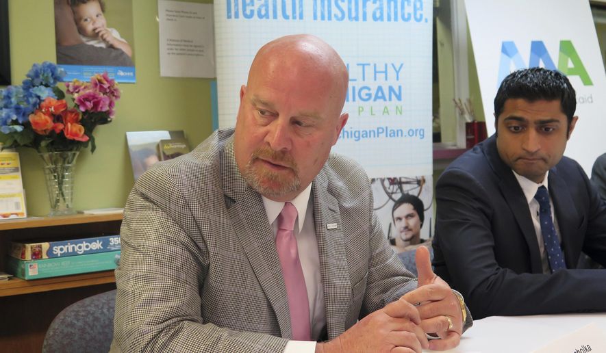 Michigan budget director Al Pscholka defends the state's Medicaid expansion program, Monday, June 5, 2017, during a briefing with reporters at the Care Free Medical and Dental Clinic in Lansing, Mich. At right is the clinic's CEO and medical director, Dr. Farhan Bhatti. Medicaid would undergo significant changes if a U.S. House-passed bill is enacted. (AP Photo/David Eggert)