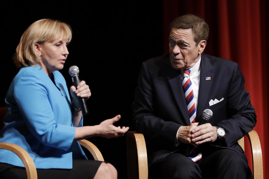 FILE - In this May 3, 2017 file photo, New Jersey Lt. Gov. Kim Guadagno, left, and former "Saturday Night Live" comedian Joe Piscopo join in a news conference in Paramus, N.J. Piscopo announced he will not be launching an independent campaign to succeed Republican Gov. Chris Christie and will endorse Guadagno during her bid in the primary elections for gubernatorial race. (AP Photo/Julio Cortez, File)