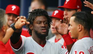 Philadelphia Phillies Odubel Herrera (37) reacts with teammates after being driven in for a score in the first inning of a baseball game against the Atlanta Braves, Monday, June 5, 2017, in Atlanta. (AP Photo/Todd Kirkland)