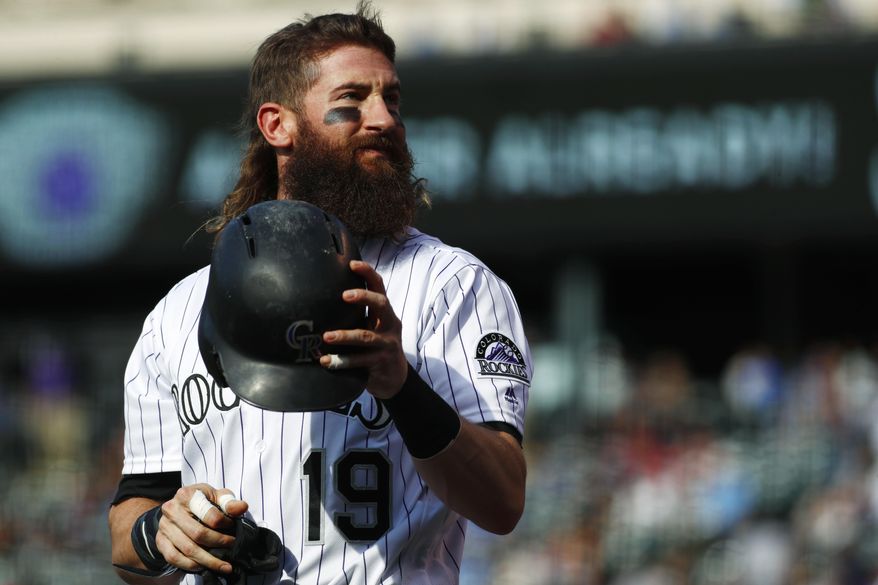 FILE - In this Tuesday, May 30, 2017, file photo, Colorado Rockies leadoff hitter Charlie Blackmon shakes out his helmet while waiting in the on-deck circle to face the Seattle Mariners in the first inning of an interleague baseball game in Denver. In spite of his idiosyncrasies, Blackmon has developed into one of the top leadoff hitters in the game. (AP Photo/David Zalubowski, File)