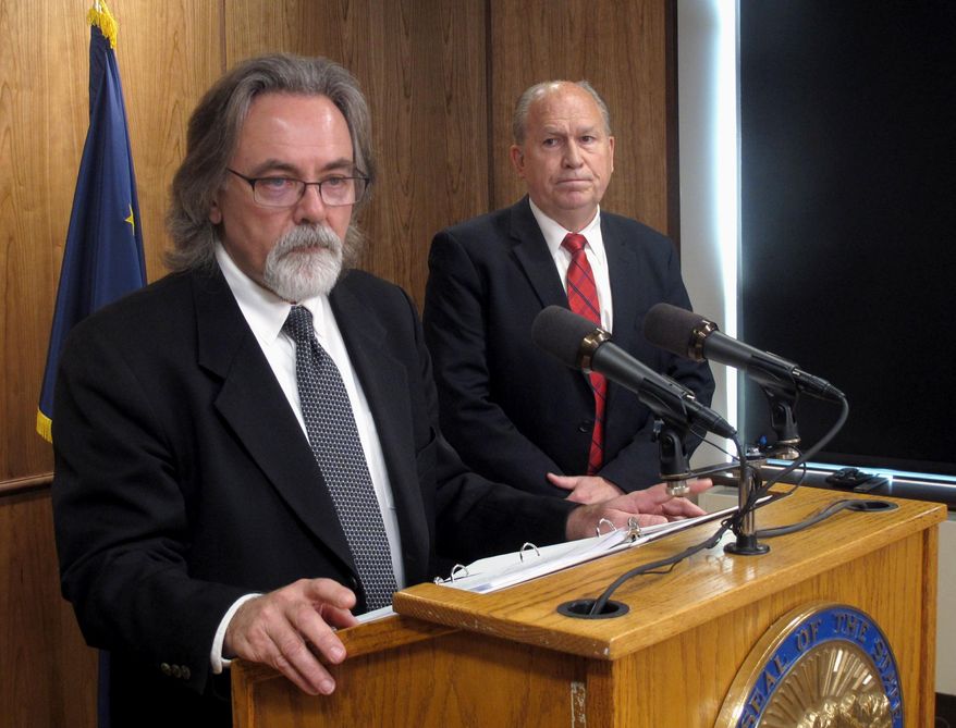 Alaska state Revenue Commissioner Randall Hoffbeck, left, addresses reporters during a news conference on Tuesday, June 6, 2017, in Juneau, Alaska, as Gov. Bill Walker looks on. (AP Photo/Becky Bohrer)