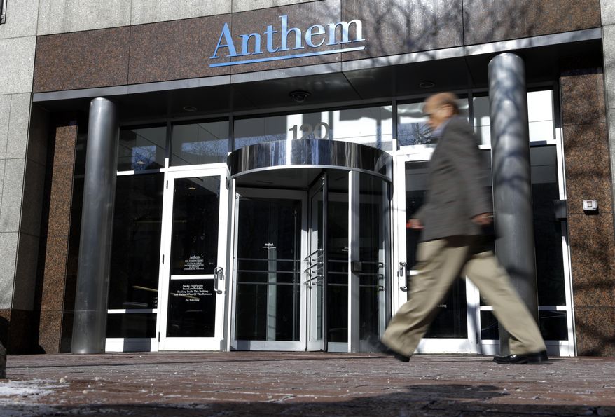 In this Thursday, Feb. 5, 2015, file photo, a man walks past health insurer Anthem's corporate headquarters in Indianapolis. (AP Photo/Michael Conroy, File)