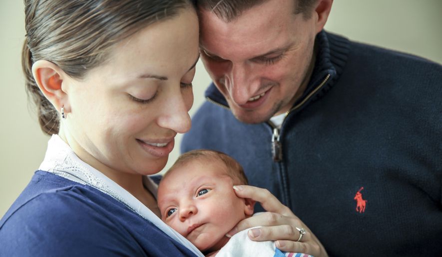 In this December 2016 photo provided by Dana J. Palmer, Sarah Murray and her husband, Tom, hold their newborn son, Owen, at Bridgeport Hospital in Bridgeport, Conn. Sarah Murray is participating in research on whether it's safe for breast cancer survivors who want to get pregnant to temporarily suspend taking hormone-blocking drugs usually recommended for five years after initial treatment. She was only 29 and planning her wedding when her breast cancer was found in 2013. (Dana J. Palmer via AP)