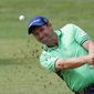 FILE - In this Sept. 16, 2016, file photo, Padraig Harrington hits the ball out of a bunker during the 73th Italy Open Golf Championship in Monza, Italy. Harrington was struck in the elbow doing a clinic and received six stiches, causing him to pull out of the FedEx St. Jude Classic this week. (AP Photo/Antonio Calanni, File)