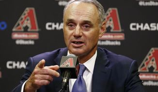Rob Manfred, Commissioner of Major League Baseball, points to a reporter to ask a question during a news conference prior to an Arizona Diamondbacks baseball game against the San Diego Padres Tuesday, June 6, 2017, in Phoenix. (AP Photo/Ross D. Franklin)
