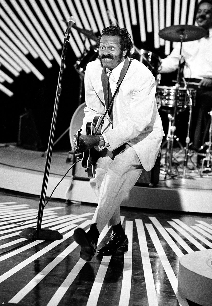FILE - This April 4, 1980 file photo shows American guitarist and singer Chuck Berry doing the "duck walk" during a performance. Berry died March 18, 2017 at the age of 90.  His last album, "Chuck," will be released on Friday, June 9, a fitting finale from the man who melded blues, rhythm and blues and country music into a sound that changed the cultural landscape.  (AP Photo, File)