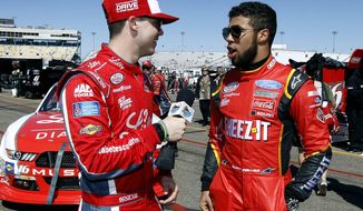 FILE - In this March 12, 2016, file photo, Ryan Reed, left, interviews fellow driver Darrell Wallace Jr. after NASCAR Xfinity Series qualifying at Phoenix International Raceway in Avondale, Ariz. Darrell Wallace Jr. will become the first black driver to race at NASCAR&#39;s top level since 2006 when he replaces injured Aric Almirola this weekend at Pocono Raceway. (AP Photo/Ralph Freso, File)
