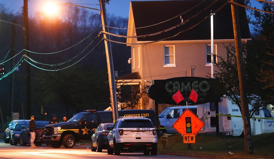 FILE - In this Sunday, March 26, 2017, file photo, a coroner's unit pulls away as police operate at a crime scene outside the Cameo club after a fatal shooting, in Cincinnati. Several victims of the gunbattle sued the nightclub, its owner and the building owner. The lawsuit filed in Hamilton County alleges the defendants failed to have a proper security plan and didn't have enough security personnel. (AP Photo/John Minchillo, File)