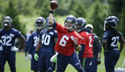 Seattle Seahawks backup quarterback Austin Davis (6) passes during NFL football practice as backup quarterback Trevone Boykin (2) looks on, Tuesday, June 6, 2017, in Renton, Wash. (AP Photo/Ted S. Warren)