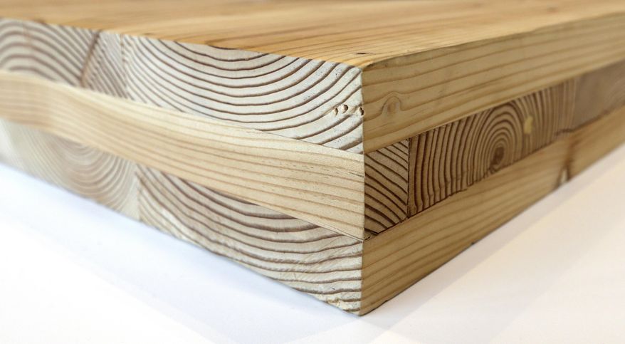 FILE--This Nov. 15, 2016, file photo shows a piece of cross-laminated timber, or CLT , in Portland, Ore. City officials in Portland have approved a construction permit for the first all-wood high-rise building in the nation. The building uses the new technology called cross-laminated timber that tests have shown can withstand the worst earthquakes. Developers worked with scientists at Portland State University and Oregon State University to prove through testing that the materials meet all building and fire safety codes. (AP Photo/Don Ryan, file)