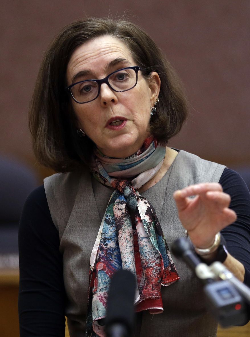 FILE - In this Jan. 26, 2017 file photo, Oregon Gov. Kate Brown speaks to media representatives in Salem, Ore. Vowing to keep the United States on track to meet its emissions-cutting target even without the U.S. government's support, more than a dozen governors, including Brown, representing nearly 40 percent of the U.S. economy by Tuesday, June 6, 2017, had pledged themselves to stay in the climate-change fight despite the Trump administration's withdrawal from the Paris climate accords last week. (AP Photo/Don Ryan, File)