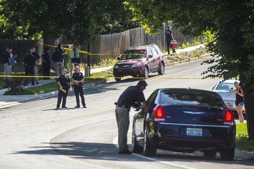 Police officers investigate the scene of a shooting in Sandy, Utah, Tuesday, June 6, 2017. Utah police say the shooter in a suburban Salt Lake City neighborhood is among several people who died in the incident and two others injured were children. The shooting took place on a neighborhood street in the suburb of Sandy, about 20 miles southeast of Salt Lake City. (Chris Detrick/The Salt Lake Tribune via AP)