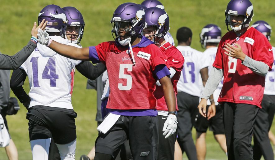 Minnesota Vikings quarterback Teddy Bridgewater (5) joins other quarterbacks including Sam Bradford, right, during the NFL football teams practice Tuesday, June 6, 2017, in Eden Prairie, Minn. Bridgewater is recovering from a knee injury that kept him out last season. Bradford was signed to replace him as starting quarterback. (AP Photo/Jim Mone)
