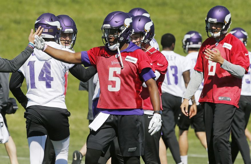 Minnesota Vikings quarterback Teddy Bridgewater (5) joins other quarterbacks including Sam Bradford, right, during the NFL football teams practice Tuesday, June 6, 2017, in Eden Prairie, Minn. Bridgewater is recovering from a knee injury that kept him out last season. Bradford was signed to replace him as starting quarterback. (AP Photo/Jim Mone)