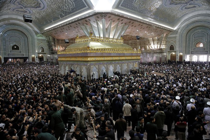 In this January 2017 file photo, mourners carry the coffin of former Iranian President Akbar Hashemi Rafsanjani during his burial at the shrine of the late revolutionary founder Ayatollah Khomeini just outside Tehran, Iran. State TV said Wednesday, June 7, 2017, that four "terrorists," including a suicide bomber, attacked the Khomeini shrine. (AP Photo/Ebrahim Noroozi, File)