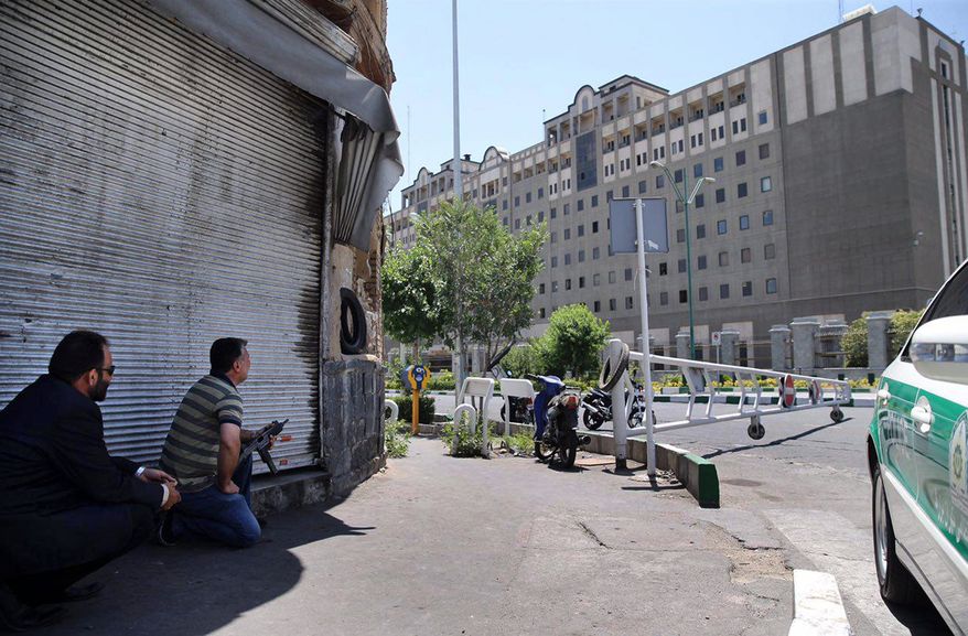 Security personnel take position in front of Iran&#x27;s parliament building after an assault by several attackers, in Tehran, Iran, Wednesday, June 7, 2017. Suicide bombers and gunmen stormed into Iran&#x27;s parliament and targeted the shrine of Ayatollah Ruhollah Khomeini on Wednesday, killing a security guard and wounding several other people in rare twin attacks, with the siege at the legislature still underway. (AP Photo/Fars News Agency, Omid Vahabzadeh)