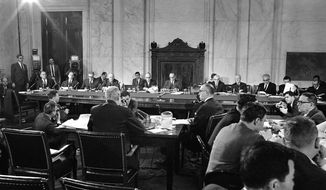 In this Feb. 10, 1966, file photo, a general views of the Senate Foreign Relations Committee hearing on Vietnam in Washington. George Kennan, former ambassador to Moscow, is at the witness table. Committee members, from left, are: Sens. Eugene McCarthy, D-Minn., Frank Carlson, R-Kansas, Bourke Hickenlooper, R-Iowa, Chairman William Fulbright, D-Ark., Wayne Morse, D-Ore., Albert Gore, D-Tenn., Frank Lausche, D-Ohio, Frank Church, D-Idaho, Joseph Clark, Jr., D-Pa., and Claiborne Pell, D-R.I. Washington knows how to do big hearings. Dramatic congressional hearings are something of a Washington art form, a rite of democracy carefully crafted for the cameras. Suspense is building as fired FBI Director James Comey prepares to claim the microphone June 8, 2017, in an austere, modern hearing room of the Hart Senate Office Building. (AP Photo/Henry Griffin, File)