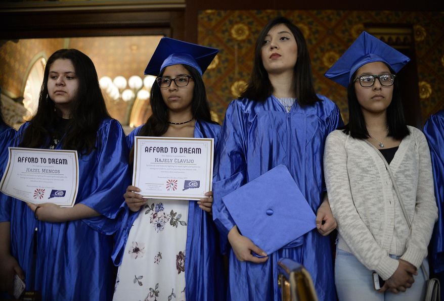 Immigrant students without legal status stand in the gallery of the Hall of the House on the final day of session at the State Capitol, Wednesday, June 7, 2017, in Hartford, Conn. A bill was pulled that would have made them eligible for financial aid. The students held a symbolic graduation on the grounds of the Capitol early in the day. (AP Photo/Jessica Hill)