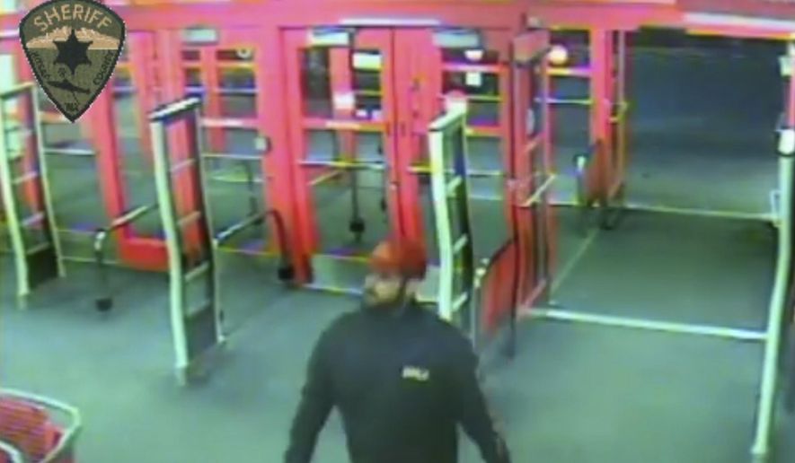 This Sunday, Jan. 15, 2017 surveillance video provided by the Kitsap County Sheriff's Office shows someone detectives describe as a person of interest in a January slaying of four members of the same family. The video, released late Tuesday, June 6 shows the man at a Target store in Silverdale, Wash., about 15 miles west of Seattle, 12 days before the killings took place. (Kitsap County Sheriff's Office via AP)