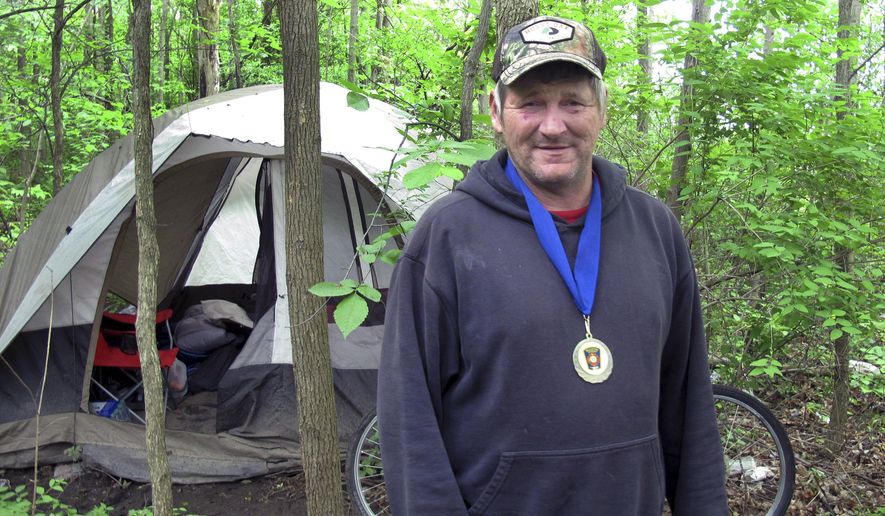 In this Monday, June 5, 2017 photo, James Pocock poses for a photo in Williston, Vt. Pocock was honored by Williston officials after he helped save the life of a truck driver whose vehicle crashed after suffering a heart attack near Pocock's home in the woods. Local emergency officials said that without Pocock's help driver Paul Bristol would have died. (AP Photo/Wilson Ring)