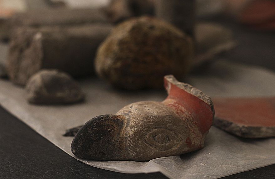 Unearthed pieces from a temple to the Aztec wind god Ehecatl lay inside a hotel where the temple was discovered in Mexico City, Wednesday, June 7, 2017. Plans to expand the hotel have been put on hold after archaeologists unearthed a 1400's temple to the Aztec wind god Ehecatl and a ceremonial ball court under the property. (AP Photo/Marco Ugarte)