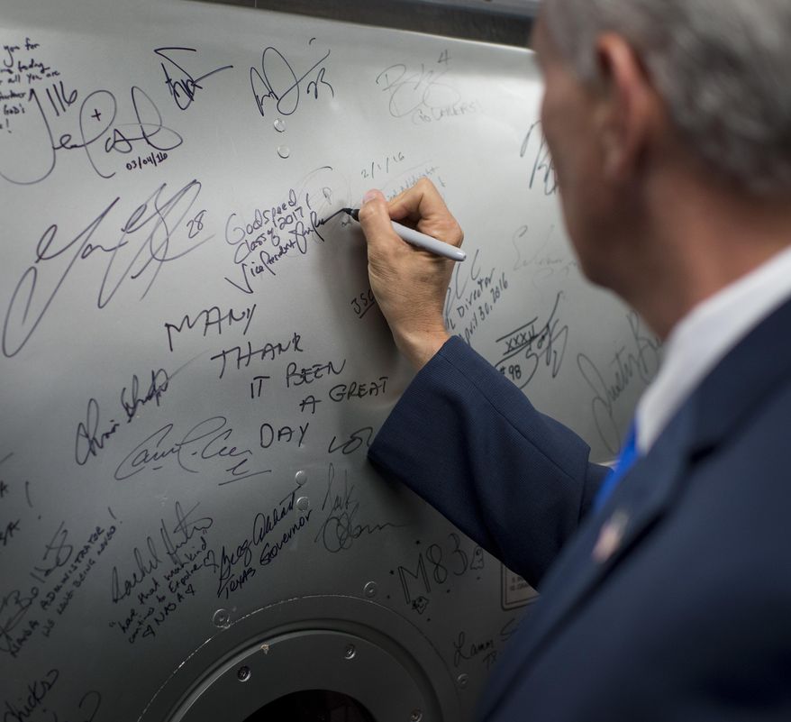In the tradition of others, Vice President Mike Pence signs a hatch from a space station training module mockup, Wednesday, June 7, 2017, at NASA's Johnson Space Center in Houston, Texas. NASA chose 12 new astronauts Wednesday from its biggest pool of applicants ever, selecting seven men and five women who could one day fly aboard the nation's next generation of spacecraft. (Bill Ingalls/NASA via AP)
