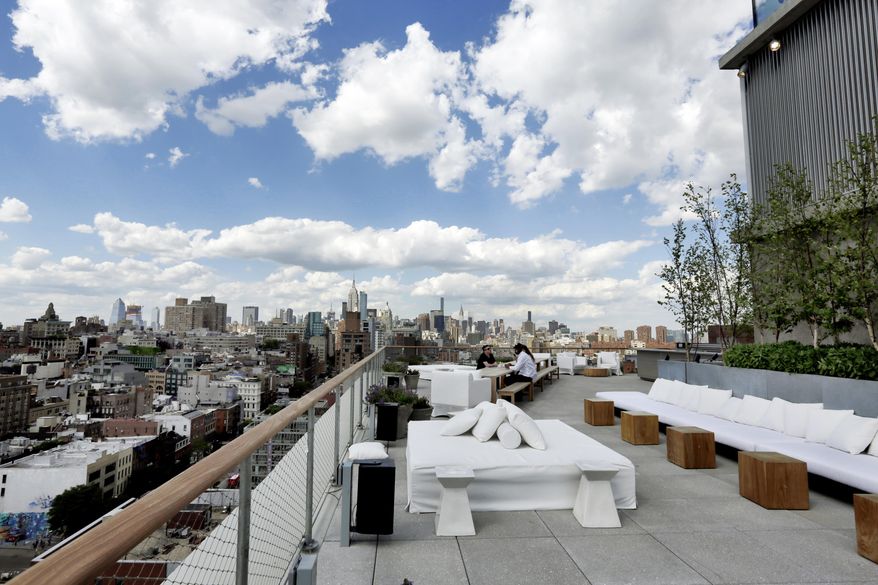This June 1, 2017 photo shows the outdoor section of the Roof bar of the PUBLIC hotel, in New York. The new hotel on Manhattan's Lower East Side opens Wednesday, June 7. It is the latest project from Ian Schrager, who's known for introducing the concept of boutique hotels and as co-founder of the legendary disco Studio 54. (AP Photo/Richard Drew)