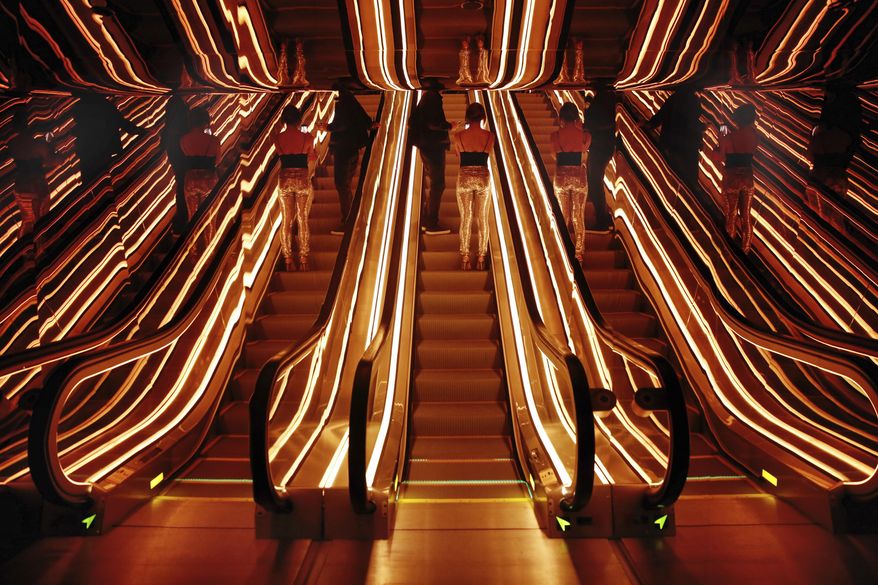 An optical illusion of a single escalator, center, in the lobby of the PUBLIC hotel, is created by its reflective surroundings, in New York, Tuesday, June 6, 2017. The new hotel opening Wednesday, June 7, 2017, on Manhattan's Lower East Side is the latest project from Ian Schrager, who's known for introducing the concept of boutique hotels and as co-founder of the legendary disco Studio 54.(AP Photo/Richard Drew)