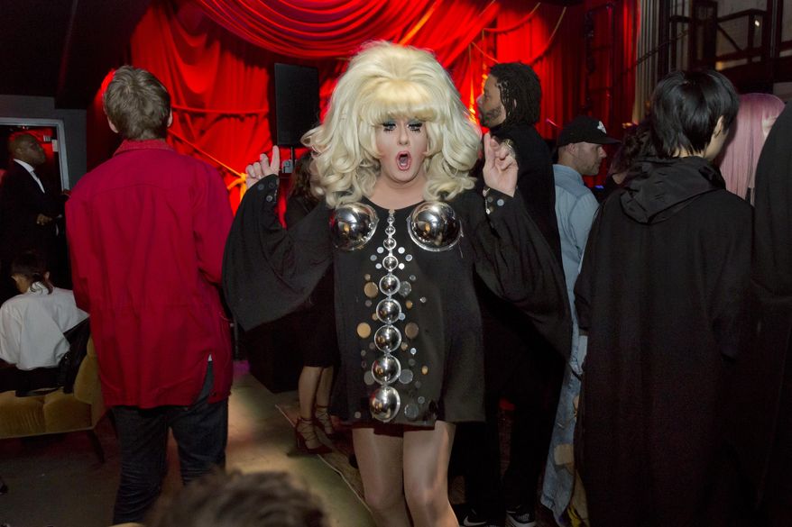 A reveler dances in the Public Art space of the PUBLIC Hotel during the opening party, in New York, Tuesday June 6, 2017. The new hotel, opening Wednesday June 7, on Manhattan's Lower East Side, is the latest project from Ian Schrager, who's known for introducing the concept of boutique hotels and as co-founder of the legendary disco Studio 54.(AP Photo/Richard Drew)