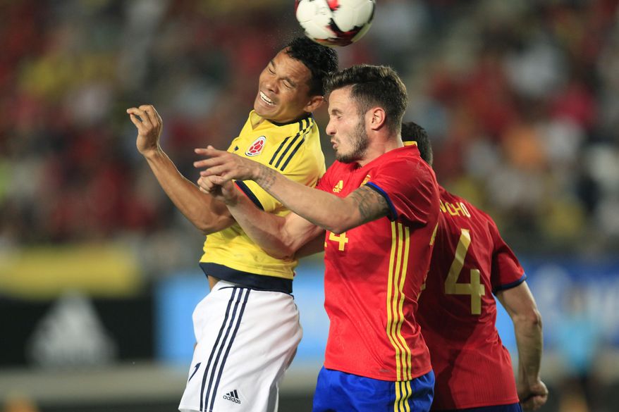 Spain's Asier Illarramendi, right, heads the ball against Colombia's Carlos Bacca, left, during the international friendly soccer match between Spain and Colombia at the Estadio Nueva Condomina in Murcia, Spain, Wednesday, June 7, 2017. (AP Photo/Alberto Saiz)