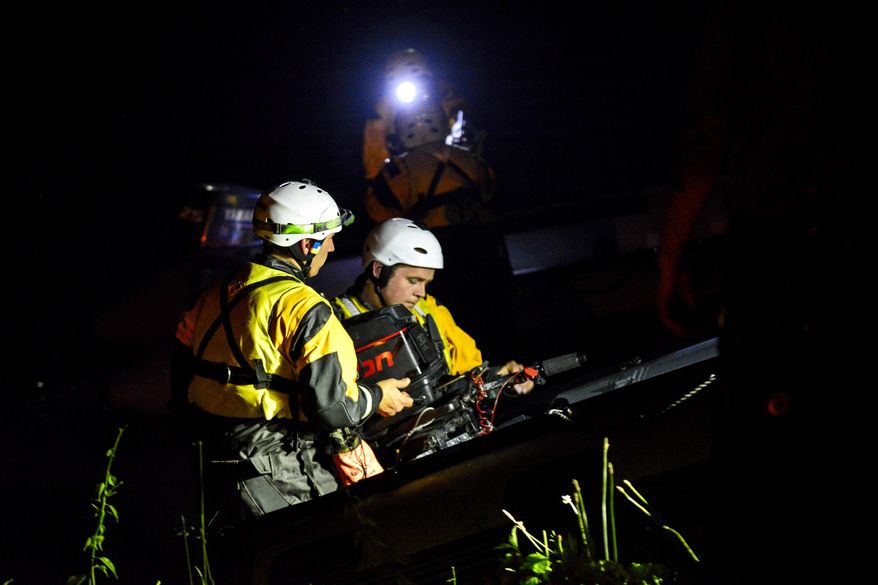 Members of Rescue Inc. load into a boat on the shores of the Connecticut River to help in the search of a man in his 20s who fell into the river on Wednesday, June 7, 2017. (Kristopher Radder/The Brattleboro Reformer via AP)