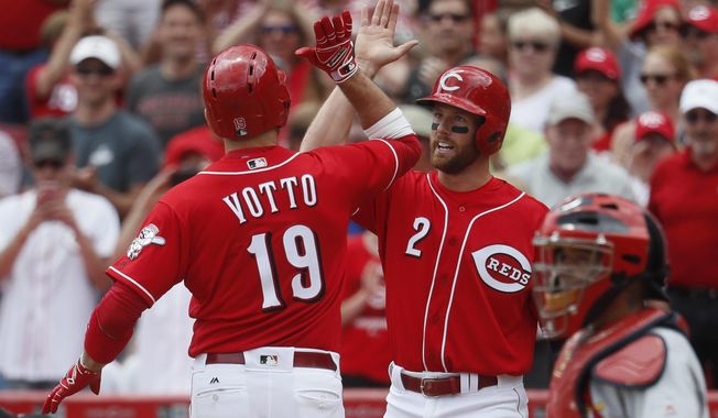 Cincinnati Reds&#x27; Joey Votto (19) celebrates with Zack Cozart (2) after hitting a two-run home run off St. Louis Cardinals relief pitcher Tyler Lyons in the sixth inning of a baseball game, Thursday, June 8, 2017, in Cincinnati. (AP Photo/John Minchillo)