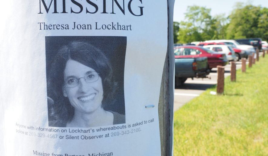 In this May 31, 2017 photo, a K9 search is conducted for Theresa Lockhart in Portage, Mich. Lockhart went missing on May 18, after she was last seen driving away from her home in Portage around 10 p.m. Police said they found her car a few miles from her home at the park and ride on Angling Road and West Centre Avenue. (Mark Bugnaski/Kalamazoo Gazette-MLive Media Group via AP)