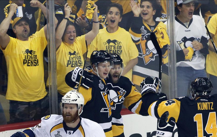 Pittsburgh Penguins' Bryan Rust, center, celebrates his goal against the Nashville Predators with Olli Maatta, left, and Chris Kunitz, right, during the first period in Game 5 of the NHL hockey Stanley Cup Final, Thursday, June 8, 2017, in Pittsburgh. (AP Photo/Gene J. Puskar)