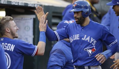 Toronto Blue Jays&#x27; Jose Bautista, right, celebrates with Josh Donaldson after scoring against the Oakland Athletics in the fourth inning of a baseball game Tuesday, June 6, 2017, in Oakland, Calif. (AP Photo/Ben Margot)