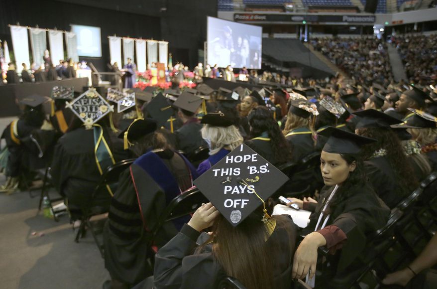 FILE - In this Dec. 17, 2016 file photo a message adorns a students mortarboard during graduation ceremonies from California State University, Sacramento, in Sacramento, Calif. Frustrated by the rising cost of college, Gov. Jerry Brown and lawmakers have floated a variety of plans to boost enrollment, restrain costs and hold University of California administrators accountable. (AP Photo/Rich Pedroncelli, File)