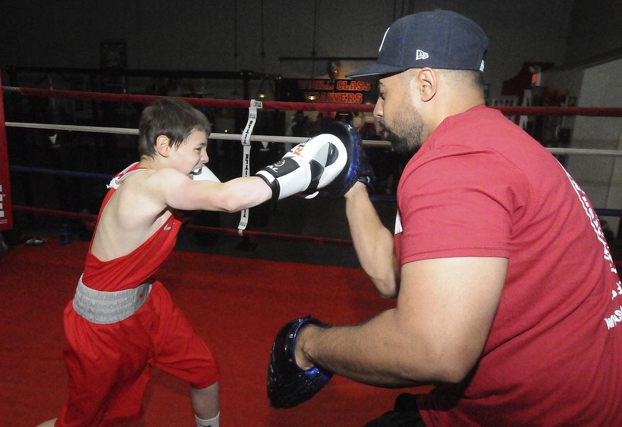 FOR RELEASE SATURDAY, JUNE 10, 2017, AT 3:01 A.M. EDT.- Marshall Schreiber, 11, of Columbus, Pa., works with his coach Freddy Anthony Rodriguez at It's On Boxing in Delran, N.J., on Thursday, May 26, 2017. Marshall Schreiber is a very accomplished boxer with thirty amateur fights on his card. He has won several championship belts in his days of competing in the ring. (Carl Kosola/The Intelligencer via AP)