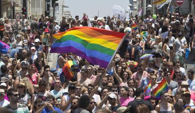 Israelis and tourists march during the Gay Pride Parade in Tel Aviv Israel Friday, June 9, 2017. About 200,000 people from the LGBT community in Israel and abroad attended in Tel Aviv&#39;s annual gay pride parade. (AP Photo/Sebastian Scheiner)