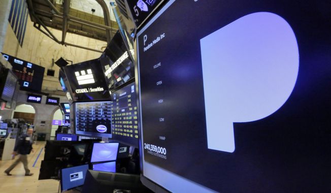 The Pandora Media name appears above a trading post on the floor of the New York Stock Exchange, Friday, June 9, 2017. (AP Photo/Richard Drew)